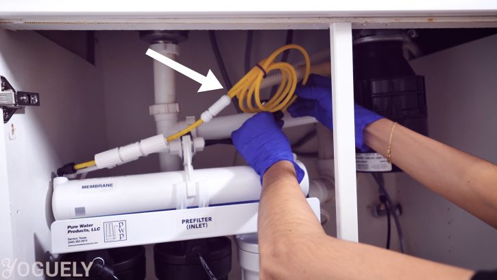 The 1/4th inch black inlet tube goes into the Inlet Port on the front of the Pre-Filter Housing. The yellow drain tube goes into the drain saddle quick connect fitting.