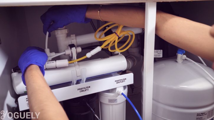 Place the water storage tank under the sink next to the reverse osmosis system.